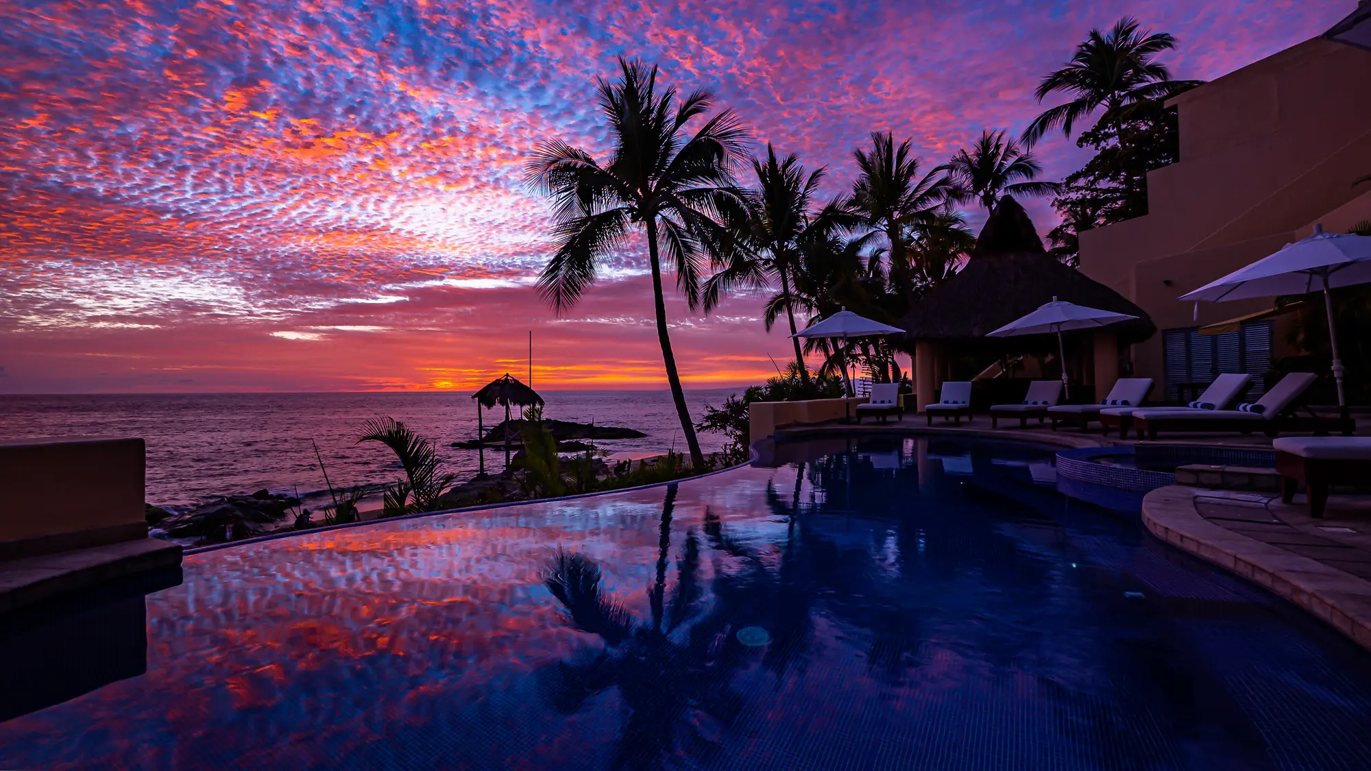 Sunset in Puerto Vallarta and infinity swimming pool with hot tub